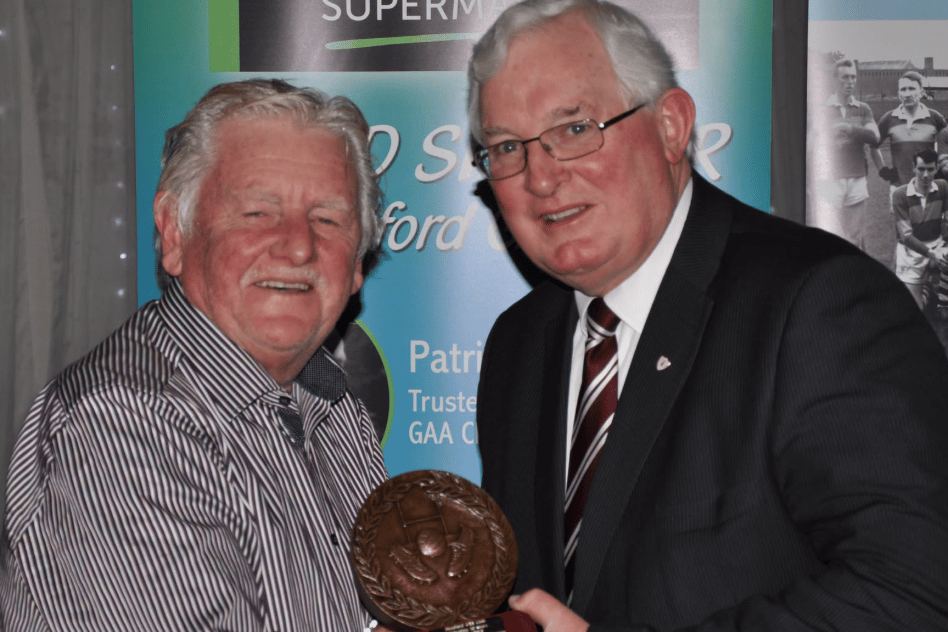 Michael Carey on the left receiving an award