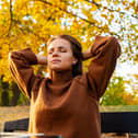 Remote worker taking mindful pause outdoors in autumn park.