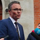 Minister Patrick O’Donovan addressing a media scrum