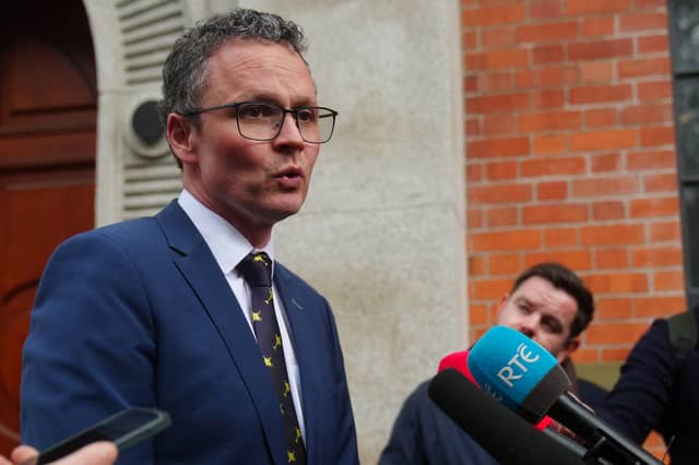 Minister Patrick O’Donovan addressing a media scrum