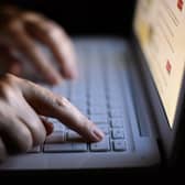 Hands on a laptop keyboard