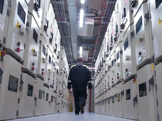 A man walking through a large data centre