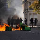 Police stand in front of burning garbage in Paris