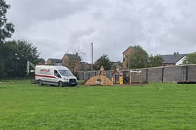 A van on site, with a number of pieces of playground equipment in place