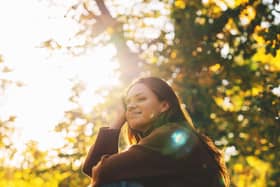 Woman shielding etes from winter sunlight (Alamy/PA)