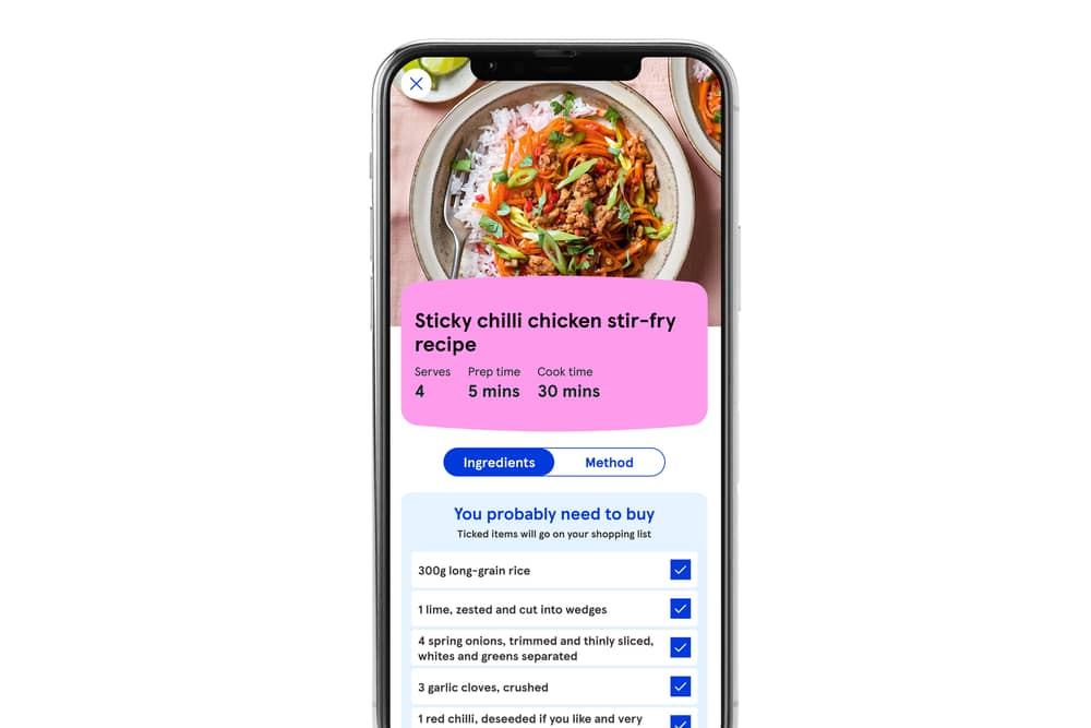 A smartphone displaying a Tesco AI assistant on the screen