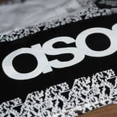 An Asos delivery package lying on the floor along with letters received in the post
