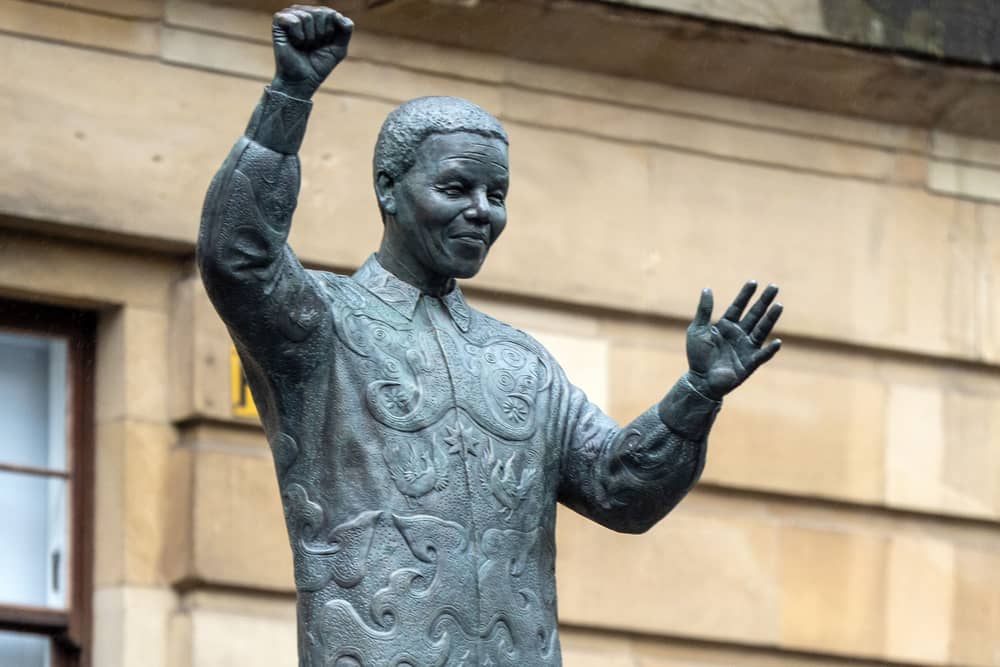 A statue of Nelson Mandela is unveiled by representatives from the Nelson Mandela Scottish Memorial Foundation, in Glasgow