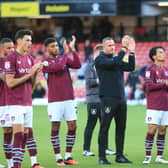 Burnley manager Nicky Hayen and players applaud the fans