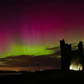 The aurora borealis lighting up skies over the ruins of Dunstanburgh Castle