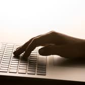 A hand on a laptop