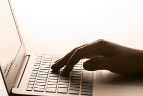A hand on a laptop