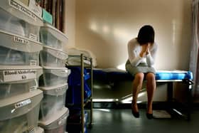 A posed picture of a woman next to police forensic rape kits