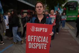 Sinead McCarville, senior housekeeper in the high dependency unit at the Mater Hospital, Dublin, takes part in a 24-hour strike outside the hospital over delays in agreeing a new public sector pay deal