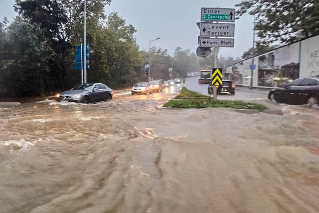 Vehicles drive along a partially flooded road during heavy rain (Omer Hamza Yildiz/DIA Photo via AP)