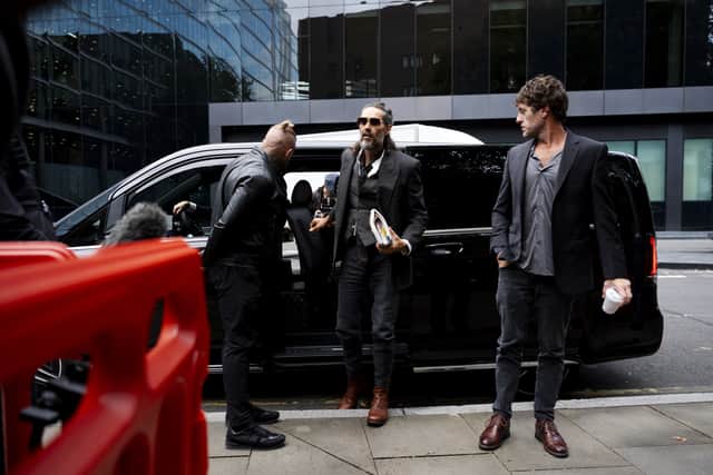 Russell Brand (centre) denies the charges (Jordan Pettitt/PA)