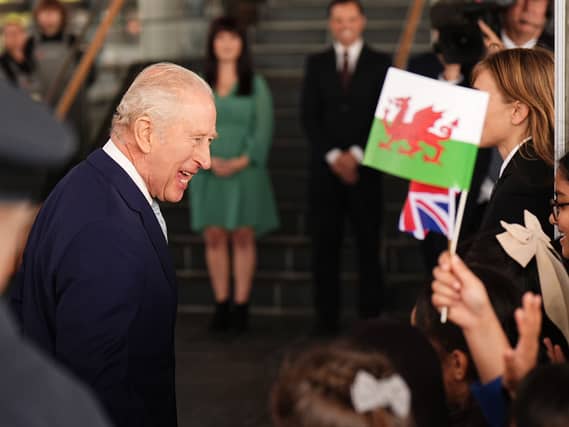 The King is greeted by school children at the ceremonial opening of the Senedd