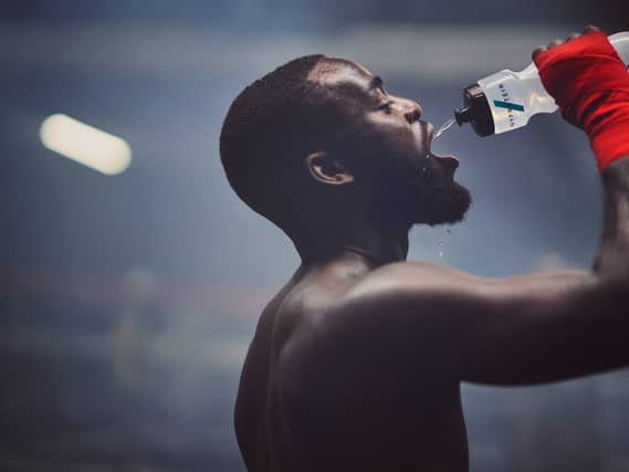 A male model drinking from a Myprotein water bottle