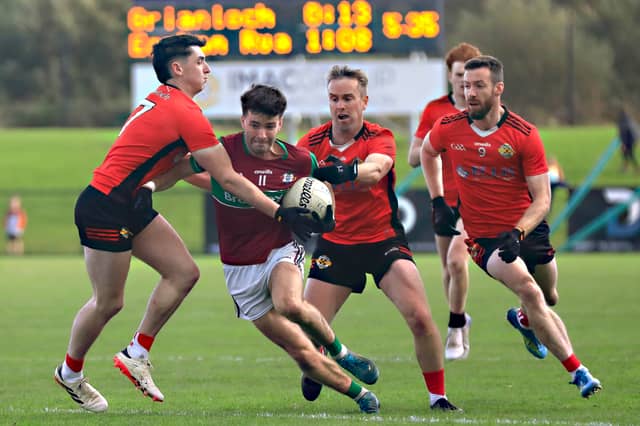Greenlough players close down Eoghan Rua forward during the McFeely Group Derry IFC semi-final.