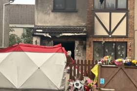 Floral tributes outside the scene of the house fire