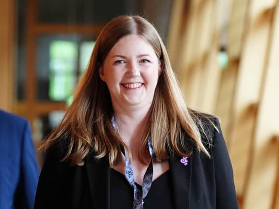 Gillian Mackay smiling in a Holyrood corridor
