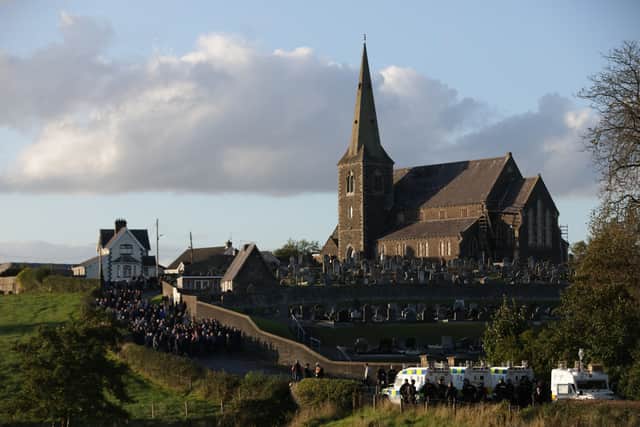 Loyalists gather near Drumcree Church as police form a barricade close to the Garvaghy Road (Peter Morrison/PA)