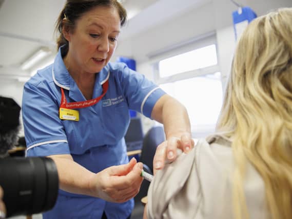 Vaccinator Alison administering the flu jab at the Ulster Hospital Vaccination Centre in Belfast