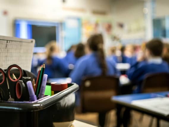 An out of focus photo of children in a classroom