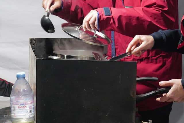 Quentin serving dinner in a Scout tent (Collect/PA Real Life)