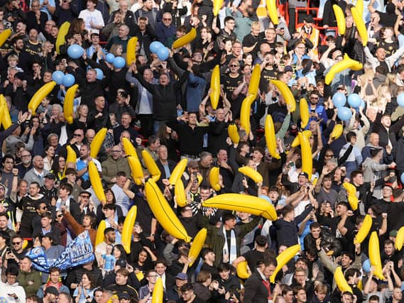 Manchester City fans hold up inflatable bananas at Anfield