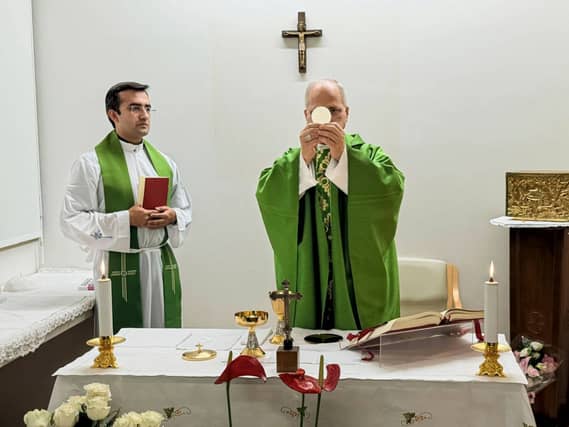 Pope Leo XIV, flanked by his personal secretary, Monsignor Edgard Iván Rimaycuna Inga, celebrating Mass