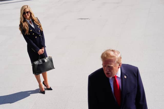 Donald Trump walks to board Marine One in Washington on Tuesday as Katie Zacharia looks on (Julia Demaree Nikhinson/AP)