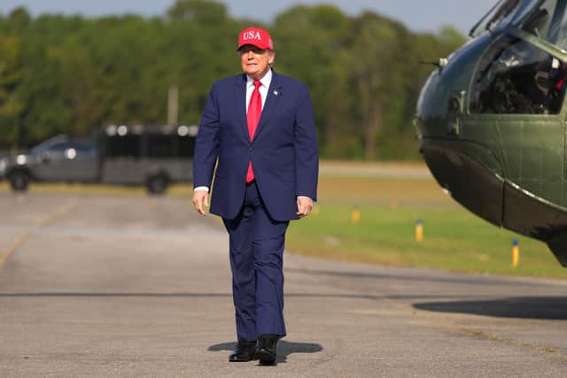 President Donald Trump arrives at a campaign rally at Dalton Municipal Airport in Dalton, Georgia (Mark Schiefelbein/AP)