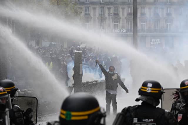 Protesters face police during a demonstration against rising living costs, joining students’ grievances, in Paris (Emma Da Silva/AP)