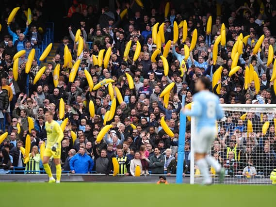 Manchester City fans with inflatable bananas in the stands against Ipswich