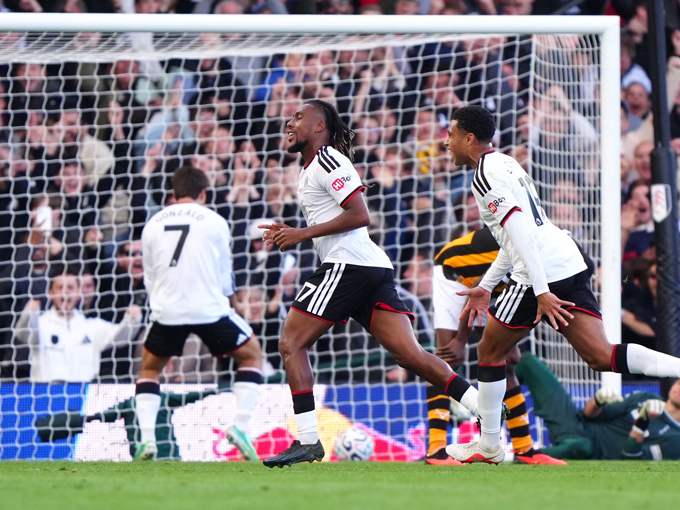 Alex Iwobi (left) celebrates scoring