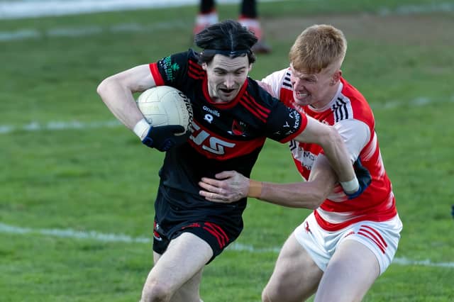 St Kevin's midfielder Jamie Smyth pushes his way clear from the challenge of David Lovely of Cappagh