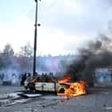 A car burns at Place de La Republique during a protest against rising living costs in Paris