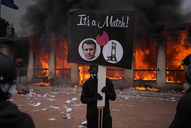 A protester holds a sign during a demonstration in Lyon (Laurent Cipriani/AP)