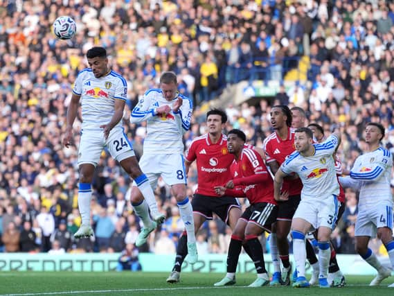 Leeds' James Justin (left) heads the ball clear from a corner