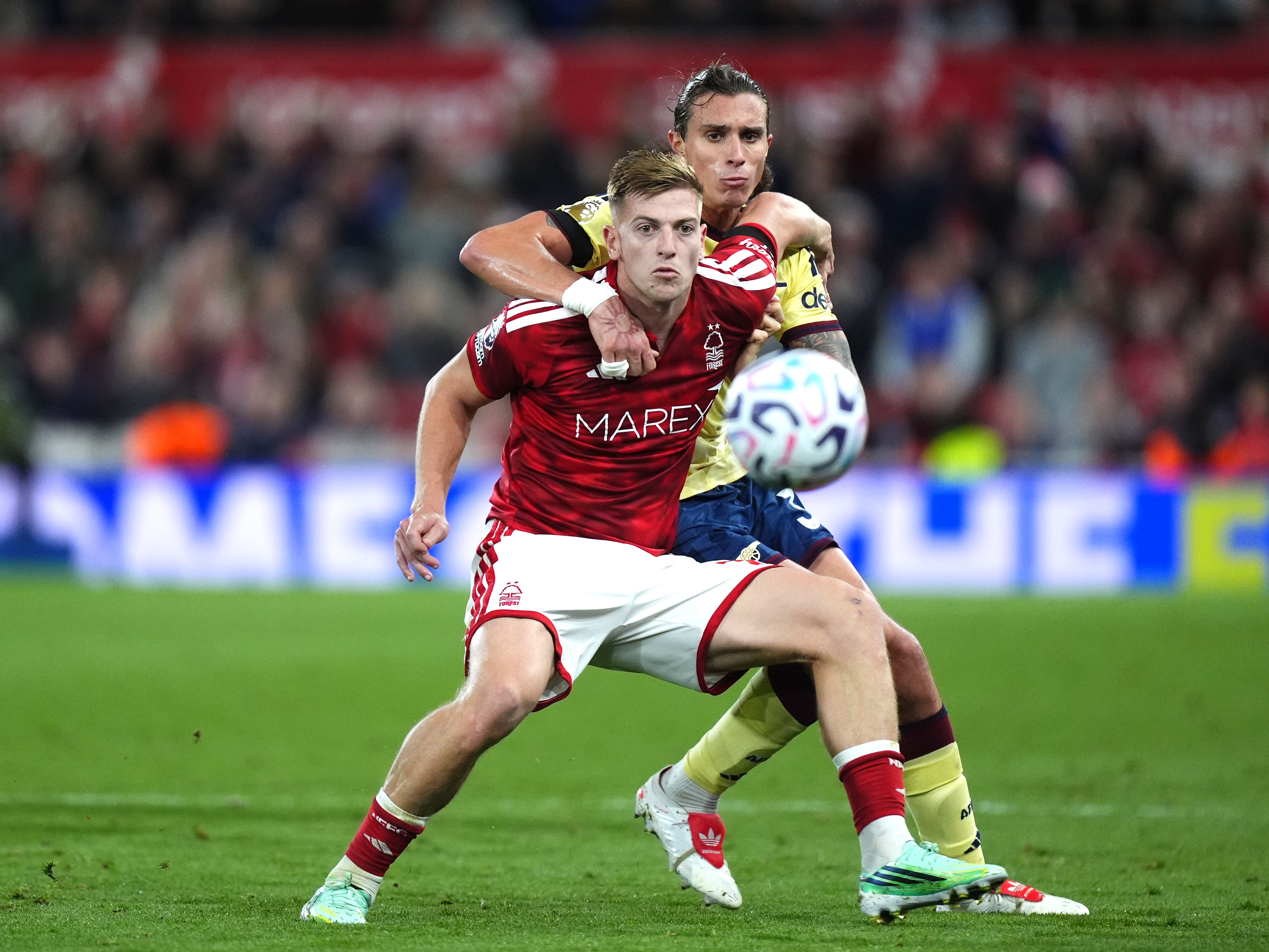 Nottingham Forest’s Liam Delap, left, and Arsenal’s Riccardo Calafiori battle for the ball