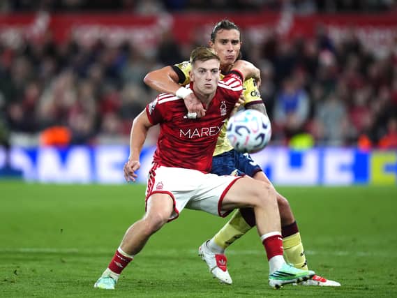 Nottingham Forest’s Liam Delap, left, and Arsenal’s Riccardo Calafiori battle for the ball