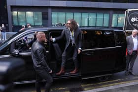 Russell Brand getting out of a car