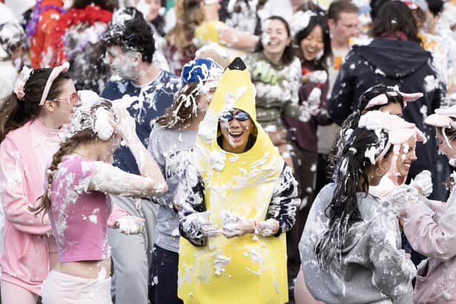 A student, centre, dressed as a banana amid the traditional Raisin Monday foam fight (Jane Barlow/PA)