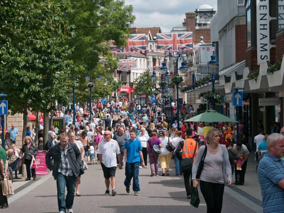 Crowded Town Centre Busy With High Street Shoppers