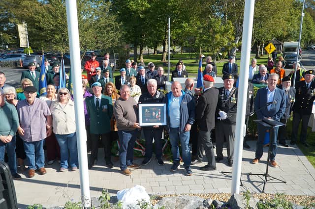 Mike Walsh of the Private James Coady Bunratty Monument Project Group presents members of the Coady family with a commemorative plaque to be erected in Pte. Coady's hometown of Carrick-on-Suir