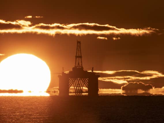 Oil platform with sun rising in background