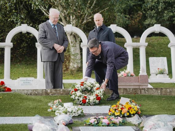 Prime Minister Andy Burnham lays a wreath with Aberfan disaster survivor Jeff Edwards (left) and Welsh Secretary Stephen Kinnock during a visit to the Aberfan Cemetery