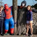 Evan Moloney and Saoirse Harnett pose for a photo with two of the scarecrows displayed in New Inn village for Spookfest a few years ago.