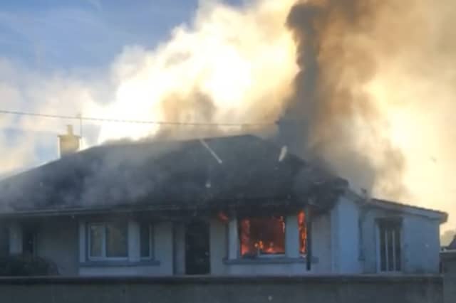 Thick plumers of black smoke from the house on fire in Manister, Croom